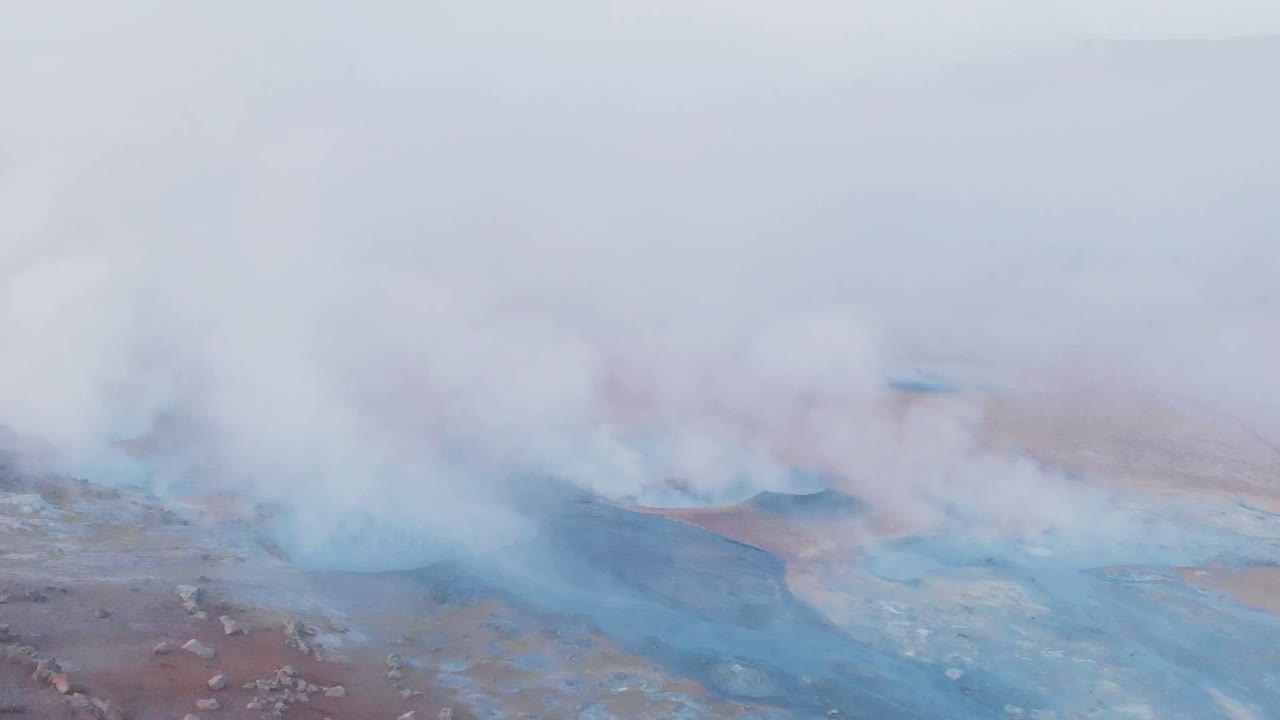 Thick smoke clouds flowing out of geothermal vents,Hveravellir,Iceland.