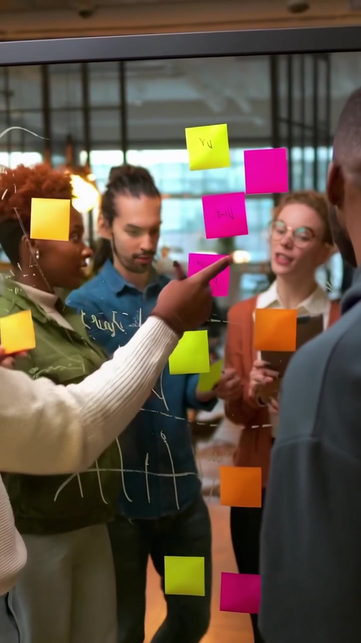 Diverse Business Team Brainstorming with Sticky Notes on Glass Board