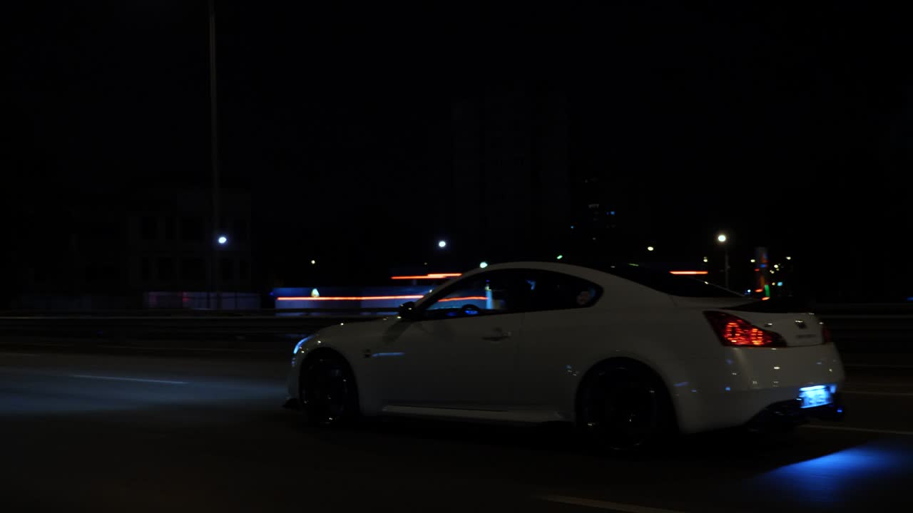 Images of a white car at night