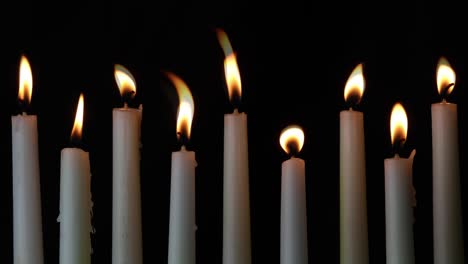 nine tall white flickering taper candles