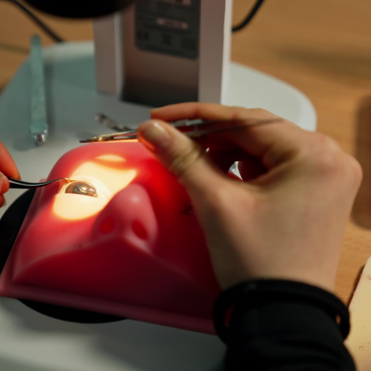 Student practicing eye surgery on a silicone model. Studying ophthalmology under microscope. Close up