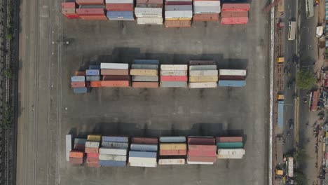 aerial top down inland shipping container depot beside highway