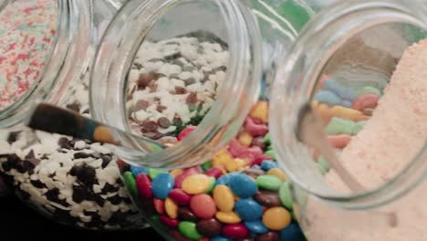 candies and chocolate sprinkles in jars in a candy store