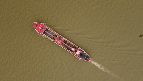 overhead shot of large cargo ship sailing by amazon river