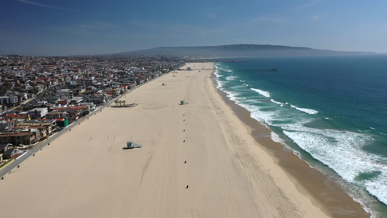 Sandy Beach And Turquoise Ocean At Manhattan Beach In California - aerial drone shot