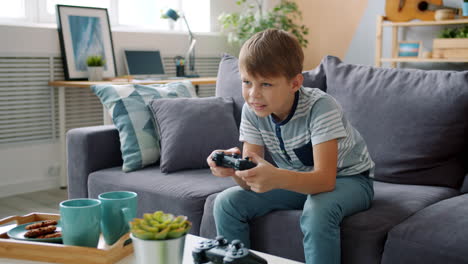 boy playing video games on couch