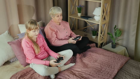 grandmother and granddaughter play video games together 1