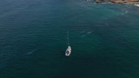 Yacht-boat-ship-sailing-at-pristine-deep-blue-clear-water-beach-bay-on-Palma-de-Mallorca-Island