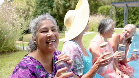 senior biracial woman enjoys a sunny outdoor gathering