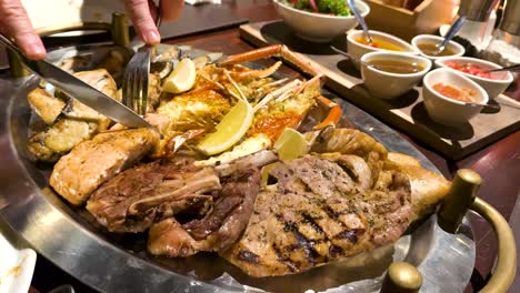 grilled seafood and meat served with sauces