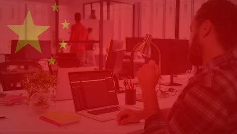 chinese flag animation over office workers using computers and collaborating