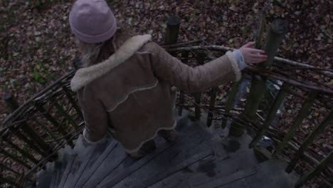 Female-descending-down-natural-stairway-from-treehouse