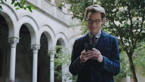 student using smartphone at university