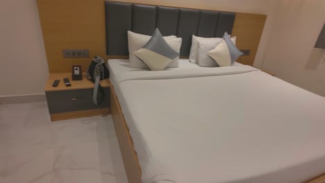 4k sweeping view of a hotel bed decorated with cushions in mysuru city, india
