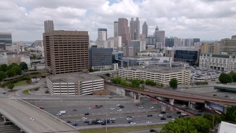 Atlanta,-Georgia-skyline-and-freeway-traffic-with-drone-video-moving-up-slowly