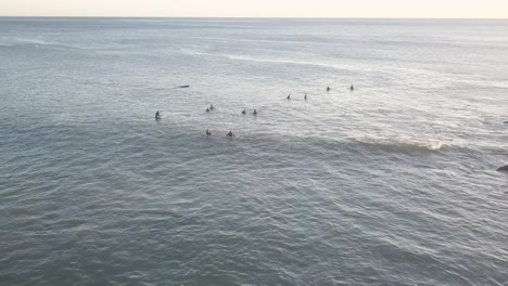 aerial view of surfers in the ocean waiting for waves