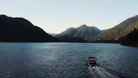 Aerial-drone-shot-following-boat-on-Indian-Arm,-an-inlet-ocean-in-British-Columbia,-Canada