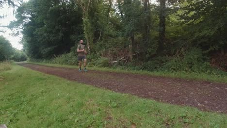 marathon runner passing camera in slow motion in early morning