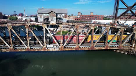 Locomotive-Passing-Over-River-On-Old-Bridge