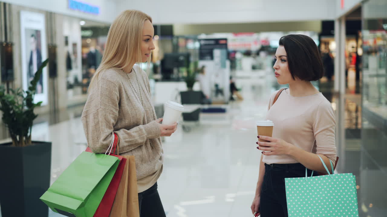 Two Women Friends Shopping and Having Coffee in a Shopping Mall