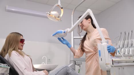 skilled dentist performing detailed procedure on patient using advanced equipment in bright clinic.
