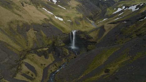 Kvernufoss-Waterfall-in-Beautiful-Iceland-Landscape---Aerial-Pull-back