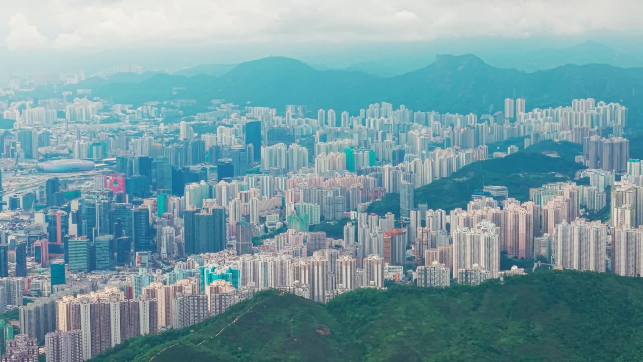 Drone shot of Kowloon area during a cloudy sunset day with the business and clutter of buildings
