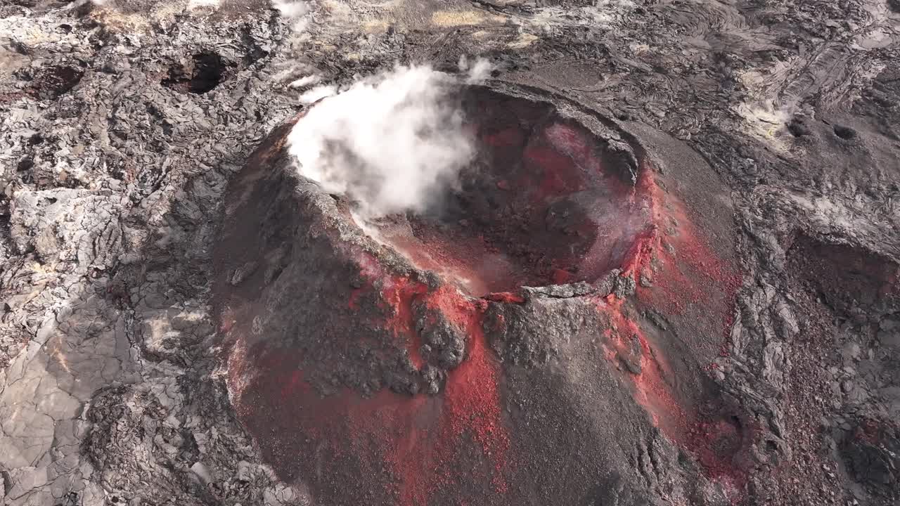 active volcanic crater emits smoke amid hardened lava landscape in iceland