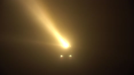 famous lighthouse at the island of texel, netherlands, in dense fog with large beams penetrating through the mist, in a long shot