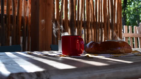 cups-of-hot-tea-with-evaporating-water-and-a-bun,-side-view