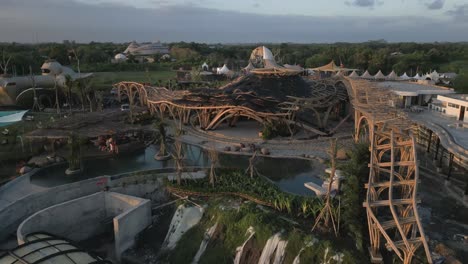 low aerial flies over unique architecture in bali resort construction