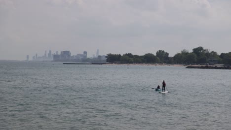 paddle boarders in lake michigan in evanston, illinois