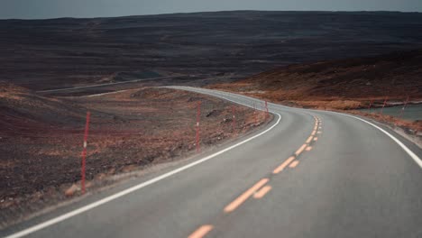 Drive-on-the-narrow-road-through-the-windswept-autumn-tundra