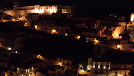 aerial view of modica alta val di noto sicily castello dei conti castle old baroque town southern italy at night_00034