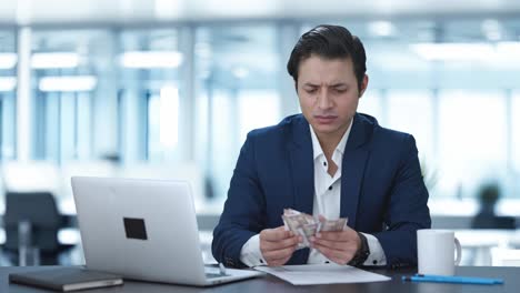 confused indian businessman counting money