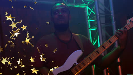 music industry musician playing electric bass amid green stage lights with floating golden stars