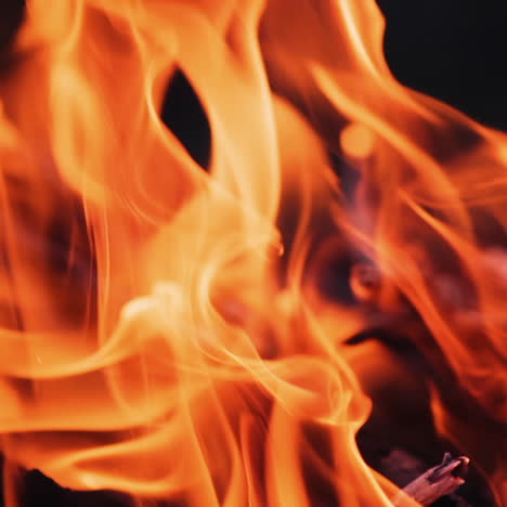 beautiful fire background. red and yellow flame of bonfire at dusk. bright flame of vivid tongues dancing in slow motion. close-up.