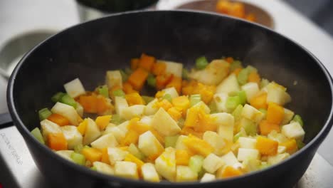 crop person adding meatballs to stew