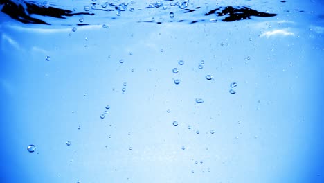 many bubbles in water close up, abstract water wave with bubbles in slow motion