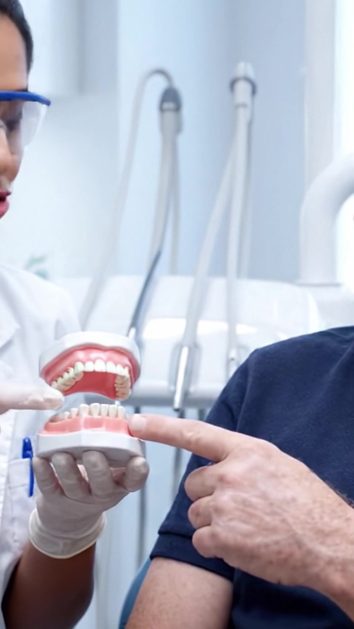 Consultazione odontoiatrica: il paziente interagisce con il dentista durante una sessione informativa sulla salute orale e sulle tecniche di corretta igiene dentale