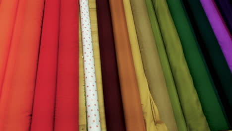 Rolls-of-colorful-fabric-displayed-in-fabric-store