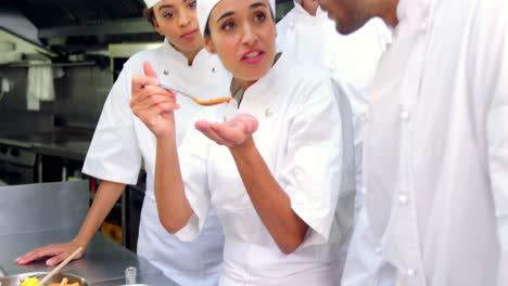 Team-of-chefs-tasting-food-in-the-kitchen