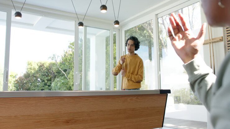 Grabbing chalk, diverse male friends chalking cue stick, planning shot at pool table in game room