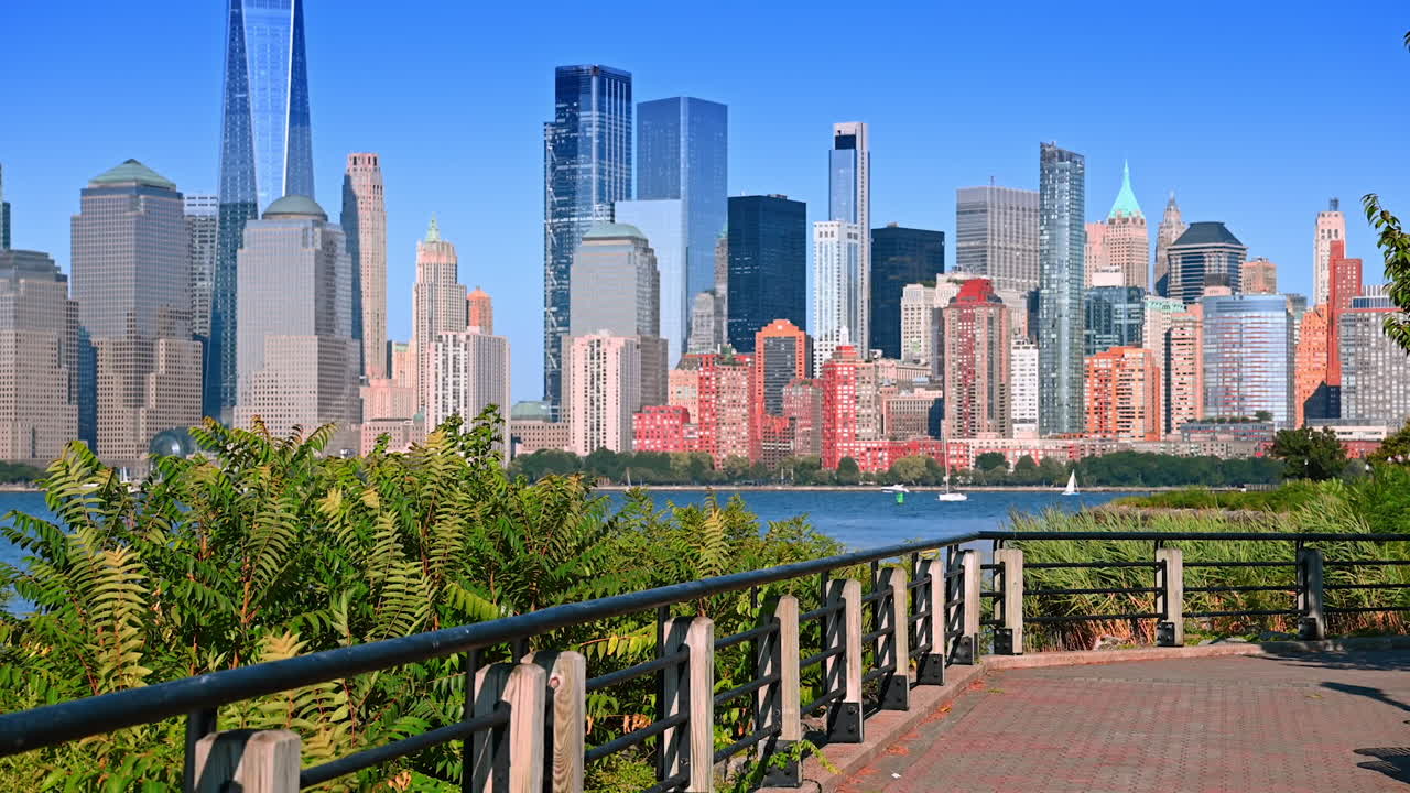 Sunny day walk by the pier along the Hudson River. Watching the fantastic skyline of Manhattan from Jersey