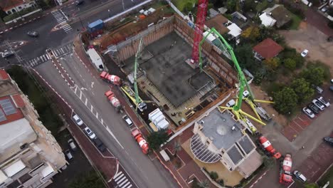 Aerial-view-of-concrete-mixer-passing-through-city-road-construction-site,-Tel-Aviv,-Israel