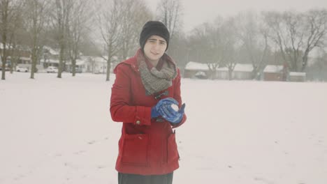 Woman-Holding-And-Playing-Snowball-In-A-Cold-Winter-Day---Handheld,-Medium-Shot