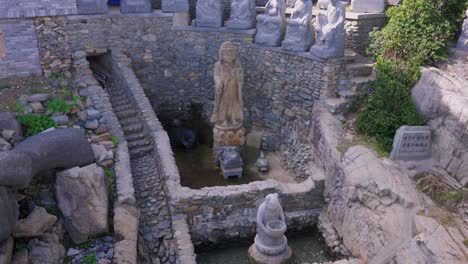 fountain for coins and luck at temple of mercy, haedong yonggungsa, busan, korea