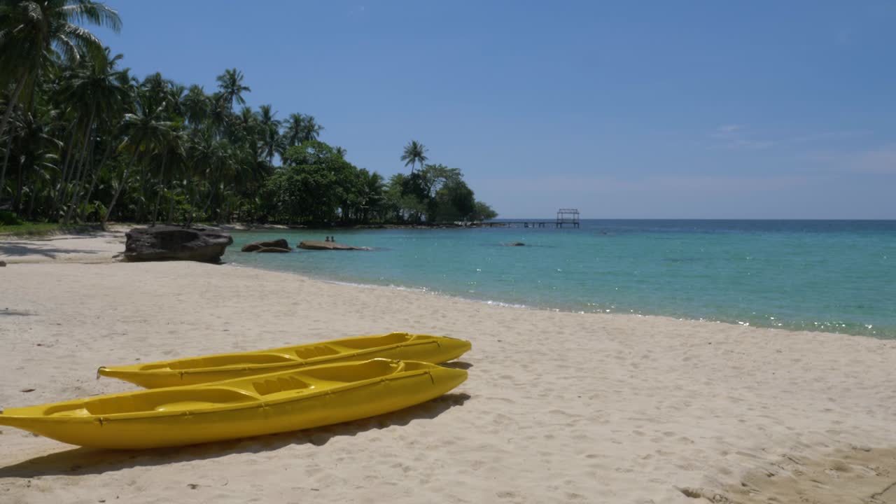 Two yellow kayaks on a tropical beach on an beautiful island