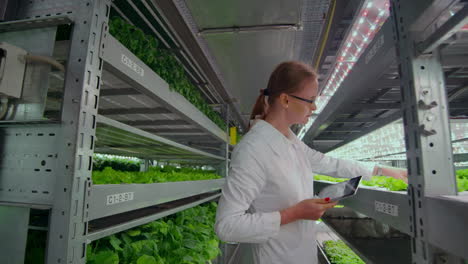 a group of men and women in white coats with tablets and computers in their hands. analyze and make the database information about grown vegetables and herbs