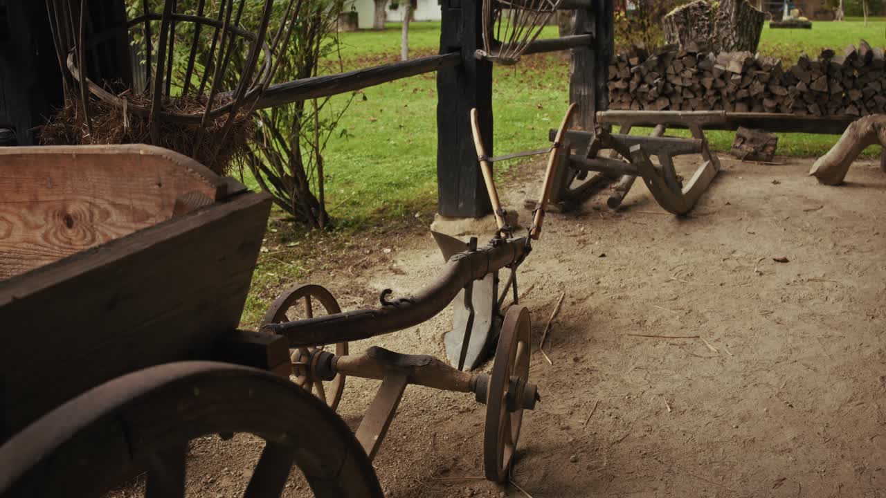 Traditional wooden cart and plow in a rustic outdoor setting in Kumrovec village